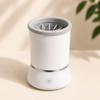 White automatic pet paw cleaner with the top opening and internal cleaning bristles visible.